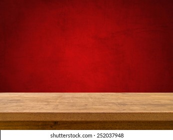 Wooden Table On Red Chalkboard Background