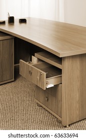 wooden table with an open box in the office