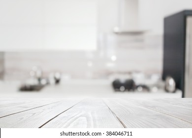 Wooden Table Over Blured Kitchen Interior Background