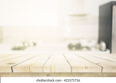 Wooden Table Over Blured Kitchen Interior Background