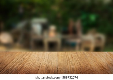 wooden table over blurred background - Shutterstock ID 589932074