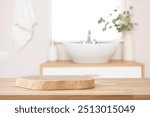 Wooden table with pedestal in blur bathroom for bathing and spa product display