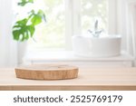 Wooden table with pedestal for product display on blurred bathroom window and sink background