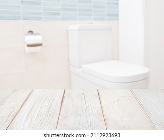 Wooden table for product display on blurred toilet seat background