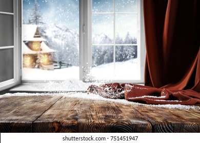 Wooden table with space for your product. Curtain in the window. Open window with snowflakes. Landscape of winter forest. Morning sunshine. - Powered by Shutterstock