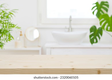 Wooden table top and defocused bathroom sink counter as background - Powered by Shutterstock