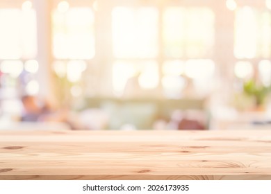 Wooden Table Top Foreground With Blurred Indoor Cafe Shop And Restaurant Background For Products Display Montage Advertising Banner.