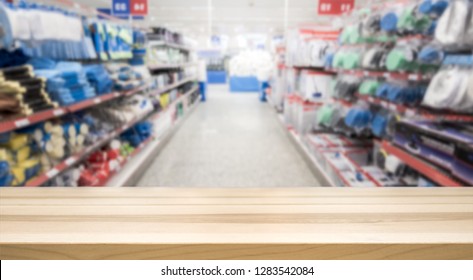 Wooden Table Top In Front Of Blurred Hardware And Grocery Store. Background For Product Display Montage. Copy Space Design.