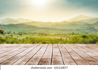 wooden table top with the mountain landscape - Shutterstock ID 652110877