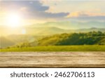 Wooden table top on blur mountain and grass field.Fresh and Relax concept.For montage product display or design key visual layout.View of copy space.