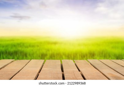Wooden table top on blur rice field background in daytime.Harvest rice or whole wheat.For montage product display or design key visual layout.View of copy space. - Shutterstock ID 2122989368