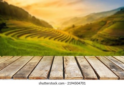 Wooden Table Top On Blur Green Tea Mountain And Grass Field.Fresh And Relax Concept.For Montage Product Display Or Design Key Visual Layout.View Of Copy Space.