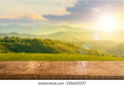 Wooden table top on blur mountain and grass field.Fresh and Relax concept.For montage product display or design key visual layout.View of copy space. - Powered by Shutterstock