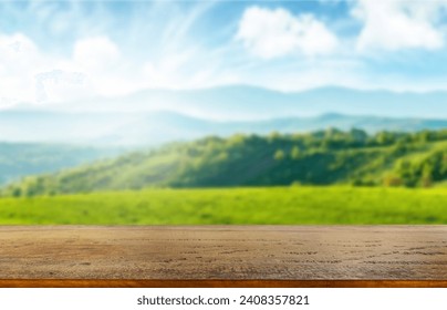 Wooden table top on blur mountain and grass field.Fresh and Relax concept.For montage product display or design key visual layout.View of copy space. - Powered by Shutterstock