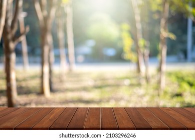 Wooden Table Top On Rubber Plantation Background, Sunlight Shines