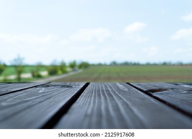 Wooden Table Top Overlooking The Vineyard In Spring. The Concept Of Seasonal Recreation Outside The City. Layout For Products And Goods.