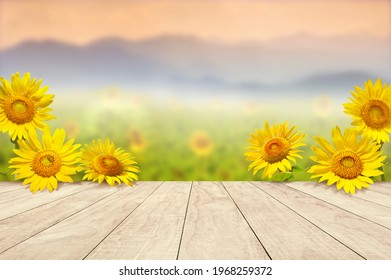 wooden table top with sunflowers  against blurry mountains landscape - Powered by Shutterstock