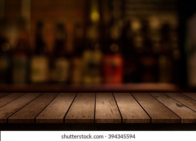 Wooden Table With A View Of Blurred Beverages Bar Backdrop