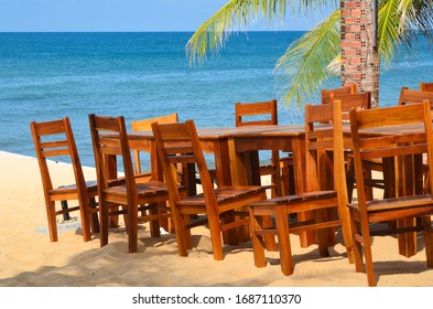 Wooden Tables And Chairs On The Beach. Outdoor Cafe. No People