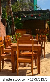 Wooden Tables And Chairs On The Beach. Outdoor Cafe. No People