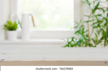 Wooden tabletop with copy space over blurred kitchen window background
