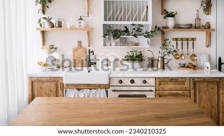 wooden tabletop with empty space on kitchen background. cozy interior with home decor, kitchenware, utensils, plates on shelf and green plants
