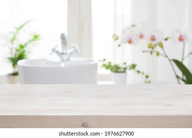 Wooden Tabletop For Product Display On Blur Bathroom Interior Background