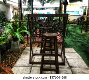 Wooden Tall Table And Wooden Round Chairs At Garden