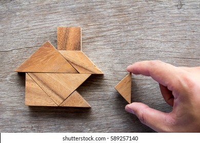 Wooden tangram puzzle wait to fulfill home shape for build dream home, happy life, house or mortgage investment concept