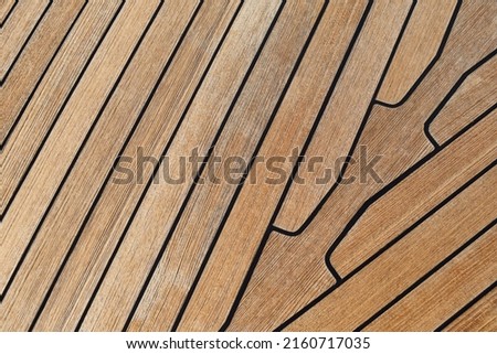 Wooden teak deack on sailboat. Background for sailors and sea lovers. 