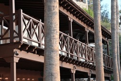 A Wooden Terrace Of A Historic Building Surrounded By Tall Palm Trees