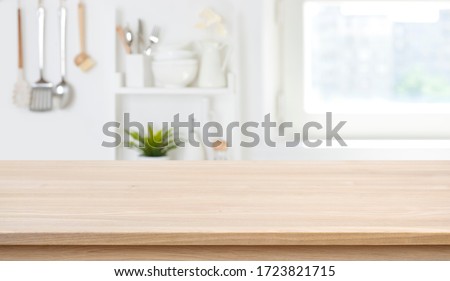 Wooden texture table top on blurred kitchen window background