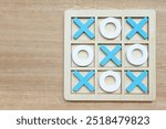 Wooden Tic tac toe game also known crosses, Tic tac toe set on wooden background.