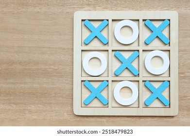 Wooden Tic tac toe game also known crosses, Tic tac toe set on wooden background. - Powered by Shutterstock