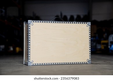 Wooden tool box with blank space for your logo and company product placement. Product in warehouse on cement floor - Shutterstock ID 2356379083