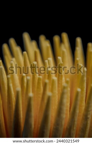 wooden toothpick background with minimalist style from top view. black background
