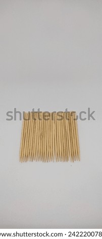 Wooden toothpick on white background. Used to remove food that is stuck and remains between the teeth