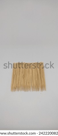 Wooden toothpick on white background. Used to remove food that is stuck and remains between the teeth