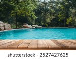 Wooden top with blurred empty Swimming pool background can be used for mocking up or display product to make advertising