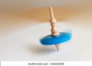 Wooden Top Toy Spinning On A Table