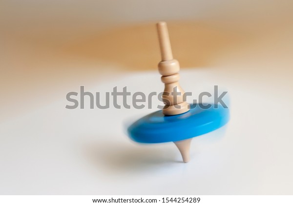 wooden Top toy spinning on a\
table