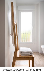 Wooden Towel Rack In A Bright Modern Bathroom