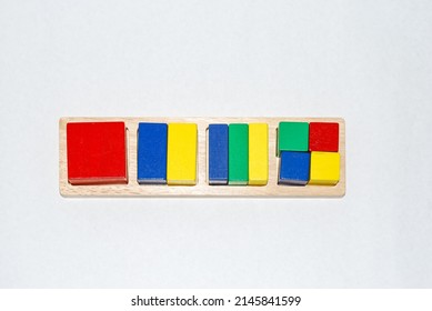 Wooden Toy For Baby, Children Isolated On White Background. Quads Of Different Colors Are Divided Into Pieces Of Different Sizes.