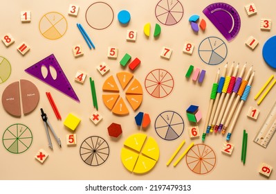 Wooden toy blocks. School supplies, math fractions, pencils, numbers, on beige background. Back to school, education concept background