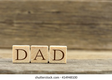 Wooden toy blocks spelling DAD with an old wooden background - Shutterstock ID 414948100