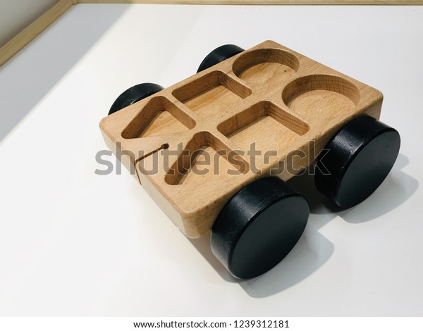 Wooden toy car on white background. Puzzle toy car.
Kids toy.