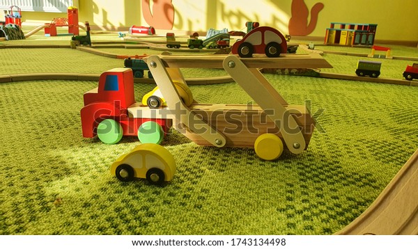 Wooden Toy Car Truck and vehicles with wooden\
track on green carpet in kids\
room