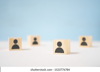 Wooden Toy Cubes With Painted Men Stand Apart From Each Other. The Concept Of Loneliness In A Crowd, Disunity, Fragmentation.