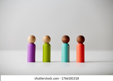 Wooden Toy Figures Concept. Different Skin Colour People, Standing All Next To Each Other, Equal To Each Other. Unknown Gender Or Age.