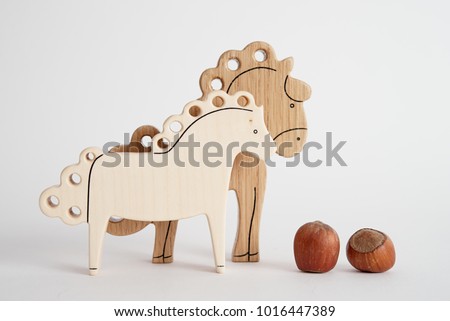 The wooden toy of horse for kids isolated light background at the studio.